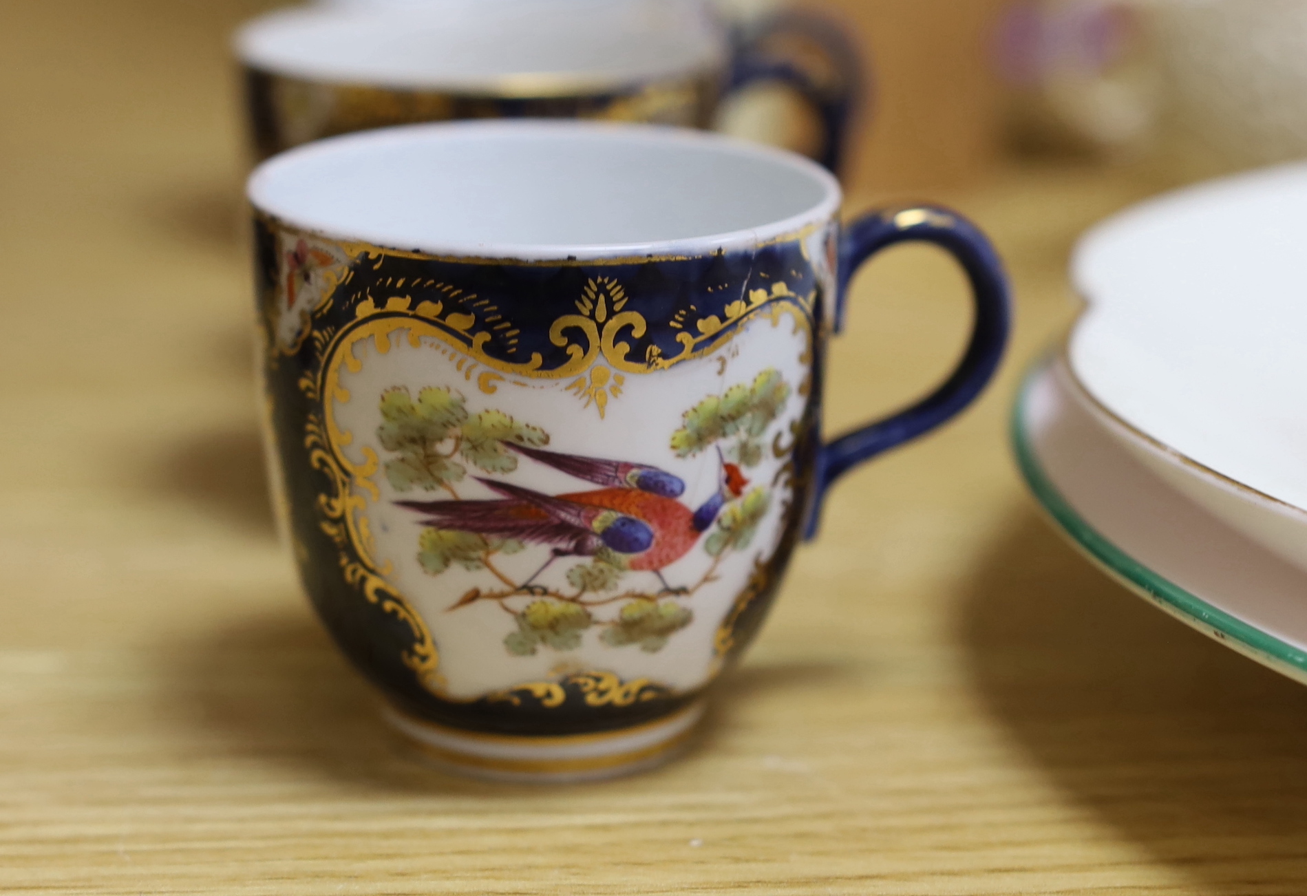 A large group of late 19th/early 20th century Royal Worcester tea wares, (some damage) including a signed bird painted pieces and signed fruit painted saucers